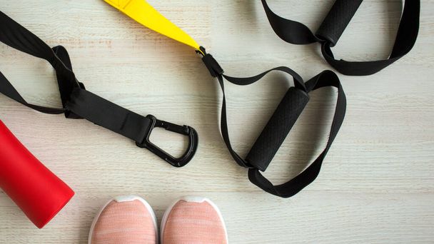 Belts of training equipment, Black loop of functional training equipment on a white background. Sports accessories. Fitness and gym items for a healthy lifestyle. Advertising banner, sport - 写真・画像