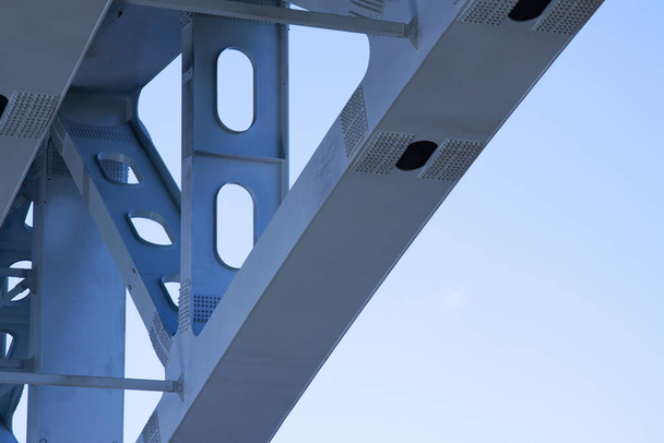 A fragment of the metal structure of the bridge over the Volga against the blue sky - Fotó, kép