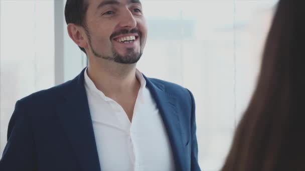 Crop. Male and female business workers are discussing issues. Successful team. Smiling boss. Copy space. Blurred white background. Close up. 4K. - Felvétel, videó