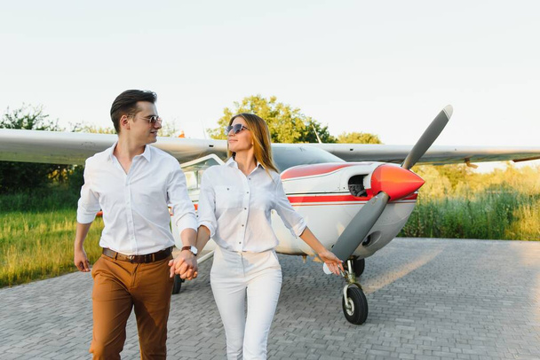 Couple in love hugging near private plane. Selective focus - Photo, Image