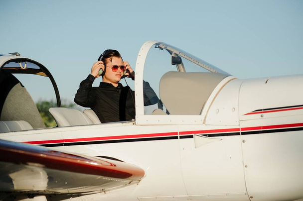 Young pilot is preparing for take off with private plane. - Foto, immagini