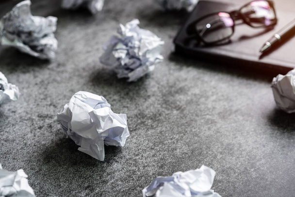 Crumpled paper balls with notebook on desk office, Creativity problems concept - Valokuva, kuva