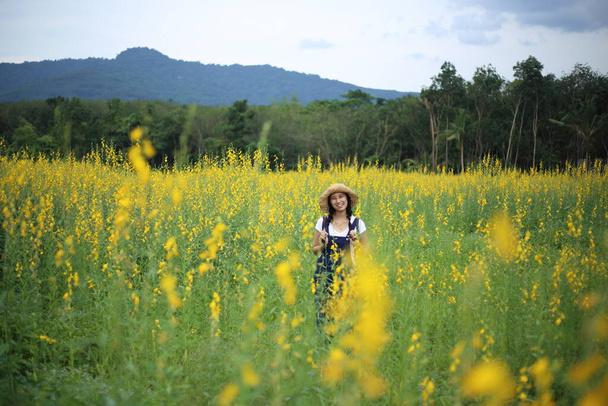 A woman standing in the crotalaria juncea field in Rayong, Thailand - Valokuva, kuva