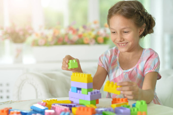 little girl playing with colorful plastic blocks - Photo, Image