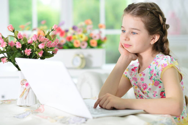  cute girl using laptop at home  - Photo, Image