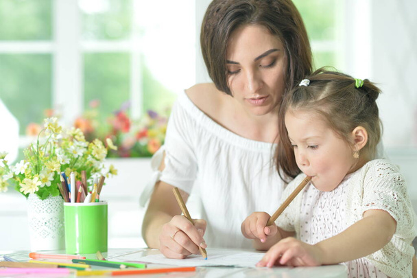 cute girl with mother drawing at the table - Foto, Imagem