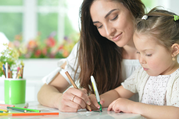 cute girl with mother drawing at the table - Photo, image