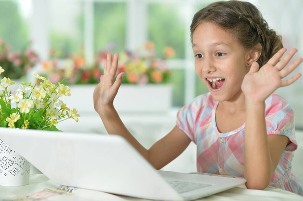 Emotional  surprised  cute girl using laptop at home - Fotó, kép
