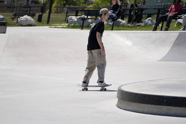 Detroit, Michigan, USA - May 31.2020: Skaters and Bikers practicing tricks at an outdoor skate park in Detroit during the Corona Virus - Photo, Image