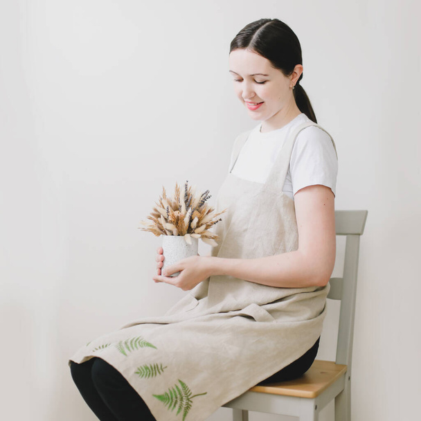 Woman in cooking linen apron. Kitchen textile. Clean natural fabric apron. Food blogger concept, homemade cooking. rustic style - Foto, Imagem