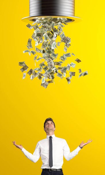 rain of dollars and businessman looking up with open arms. concept of wealth, success, winnings. - Foto, Bild