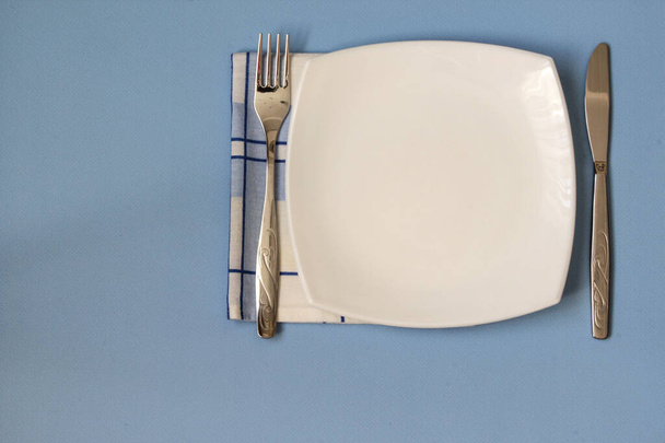 Table setting. Empty plate, knife, fork and napkin. Top view and flat lay with copy space - Fotografie, Obrázek
