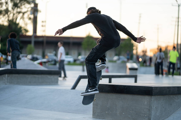 Detroit, Michigan, USA - 07.14.2019: Skaters are practicing their tricks at sunset in the skate park in Detroit - Foto, Imagem