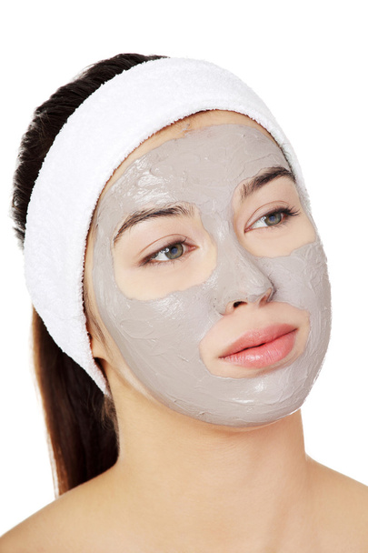 Beautiful woman with clay facial mask - Photo, Image
