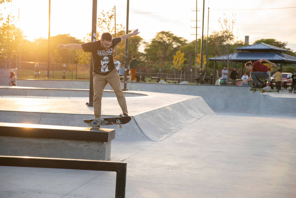 Detroit, Michigan, USA - 10.10.2019: Skaters and bikers practice tricks at dusk in Detroit. - Photo, Image