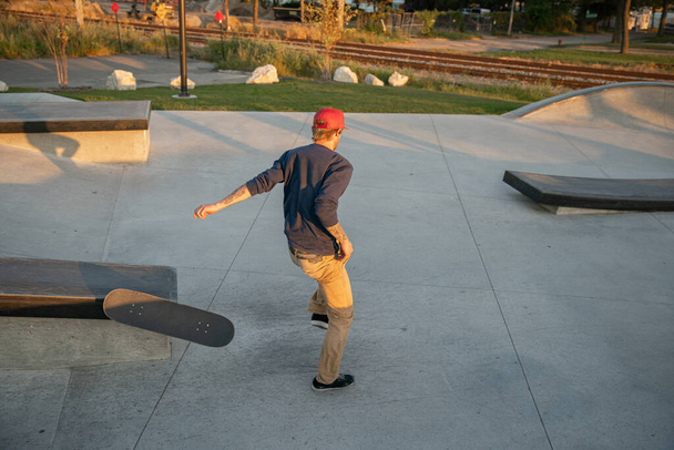 Detroit, Michigan, USA - 10.20.2019: skaters and bikers practice tricks at sunset in a Detroit skate park. - Photo, Image
