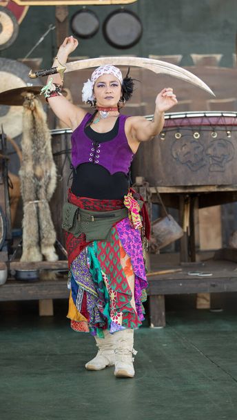 Frau führt interpretativen Tanz auf hölzernem Bühnenhintergrund auf - Foto, Bild
