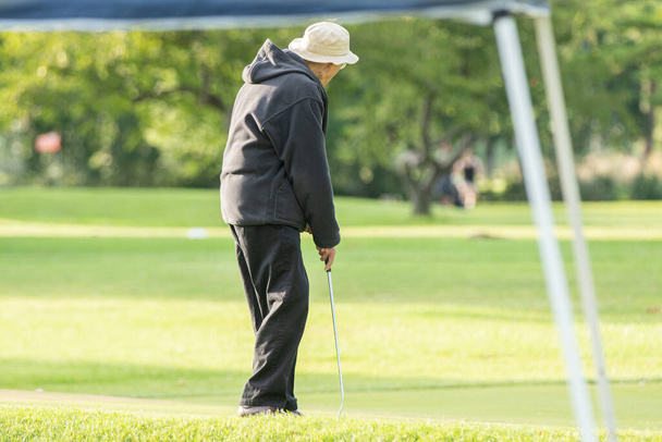 unknown golfer is lining up his shot - Φωτογραφία, εικόνα