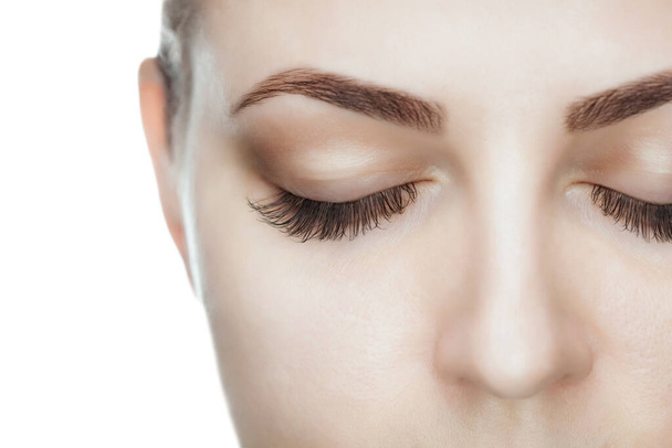 Beautiful Woman with long lashes in a beauty salon. Eyelash extension procedure. - Photo, Image