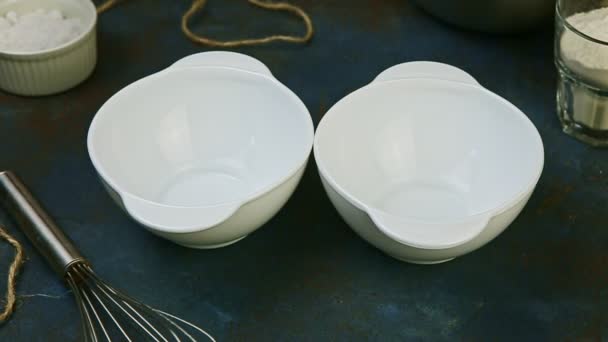 top view closeup on two small empty white bowls stand on dark kitchen table - Footage, Video