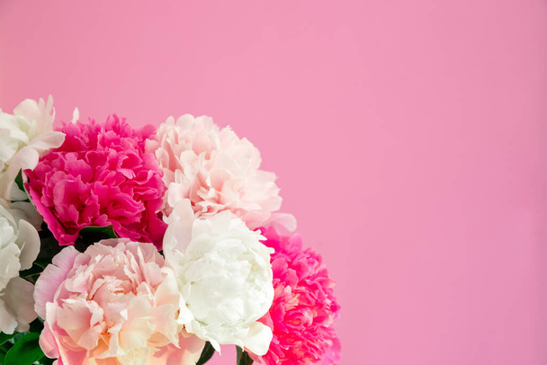 Bouquet beautiful flowers on pink background. Universal greeting card. FLatlay with pionies. - 写真・画像