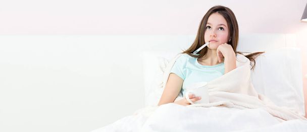 Teen girl lying in bed with a high fever - Fotoğraf, Görsel