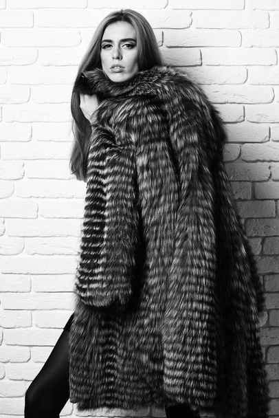 fashionable sexy woman in fur on brick wall studio background - Photo, Image