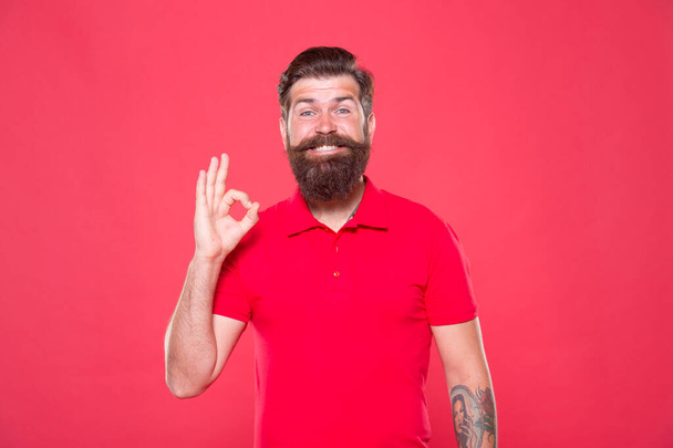 Best haircut here. Hairdresser salon. Brutality and confidence. Barbershop model. Promoting barber services. Portrait of bearded man red background. Brutal guy with mustache. Hipster with beard - Photo, image