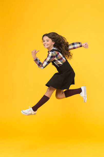Break into. Feel inner energy. Girl with long hair jumping on yellow background. Carefree kid summer holiday. Time for fun. Active girl feel freedom. Fun and jump. Happy childrens day. Jump concept - Fotó, kép
