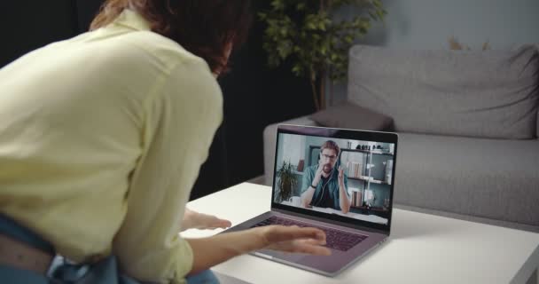 Business woman having video call with partner on laptop - Materiał filmowy, wideo