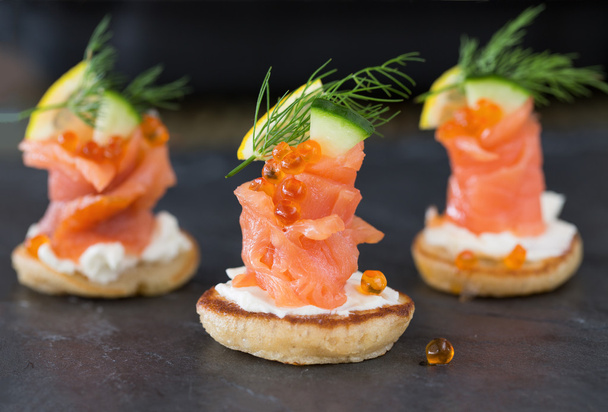 Blini with smoked salmon and sour cream, garnished with dill. Cl - 写真・画像