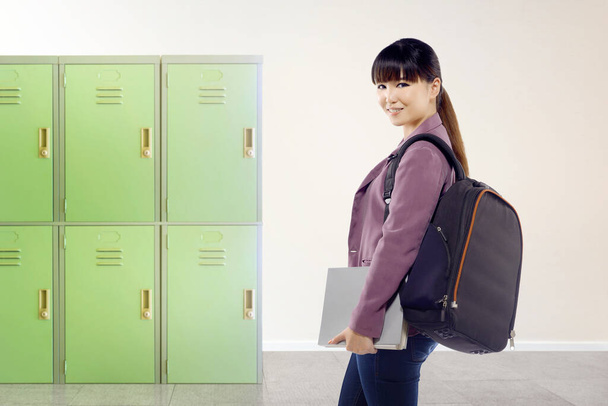 Asian student woman with backpack and book on the school. Back to School concept - Fotó, kép