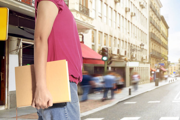 Student woman carrying a book going to the school. Back to School concept - Foto, Imagem