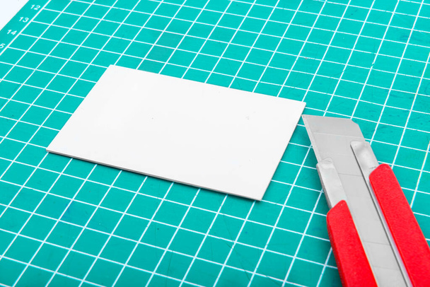 Paper and cutter on the cutting mat - Fotoğraf, Görsel
