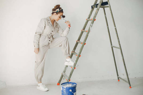 The young and cute woman repairs the room - Foto, Bild