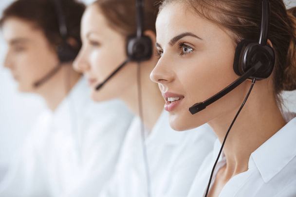 Call center. Beautiful young woman using headset and computer to help customers. Business concept - Foto, Bild