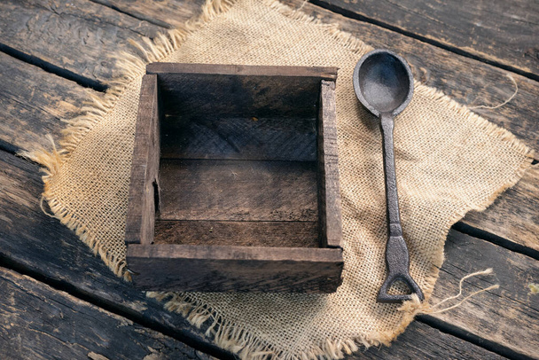 Wooden container box and spoon on old wooden table background. - Foto, Imagem