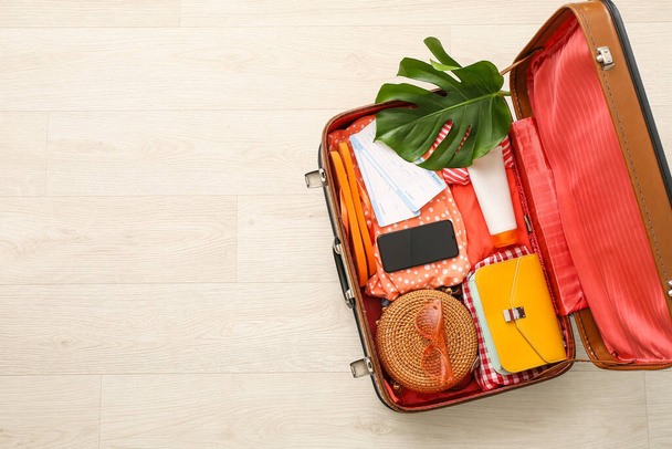 Packed suitcase on light background. Travel concept - Photo, Image