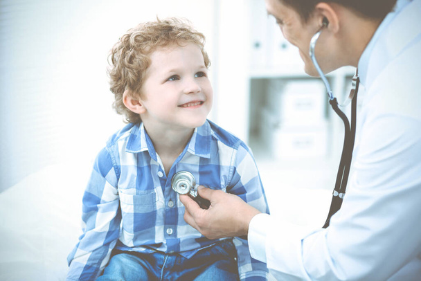 Doctor and patient child. Physician examining little boy. Regular medical visit in clinic. Medicine and health care concept - Φωτογραφία, εικόνα