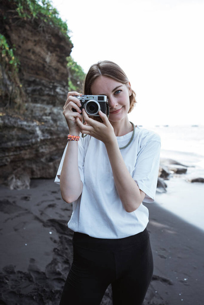 Female photographer taking photo with her camera - Фото, зображення