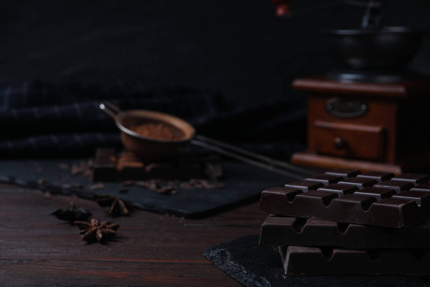 Tasty dark chocolate bars on wooden table - Фото, зображення