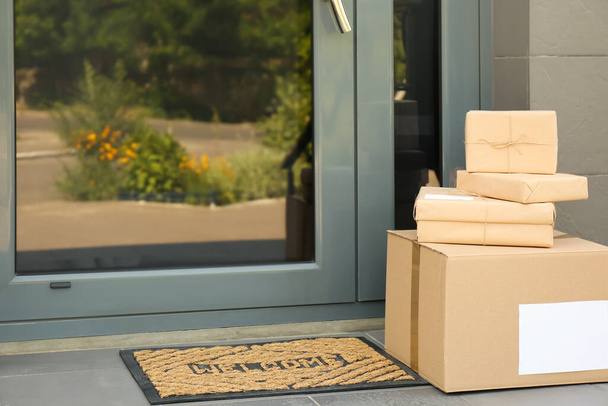 Cardboard boxes near door. Parcel delivery service - Fotografie, Obrázek