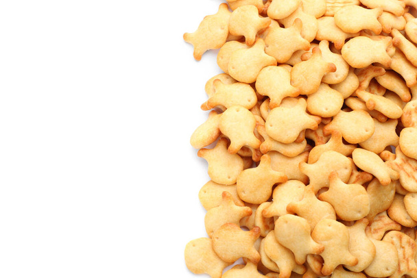 Delicious crispy goldfish crackers on white background, top view - Photo, image