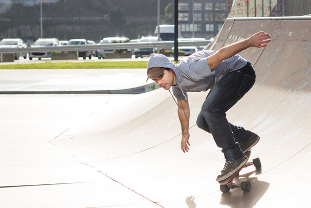 Skateboarder in action in the skate park. - Фото, зображення