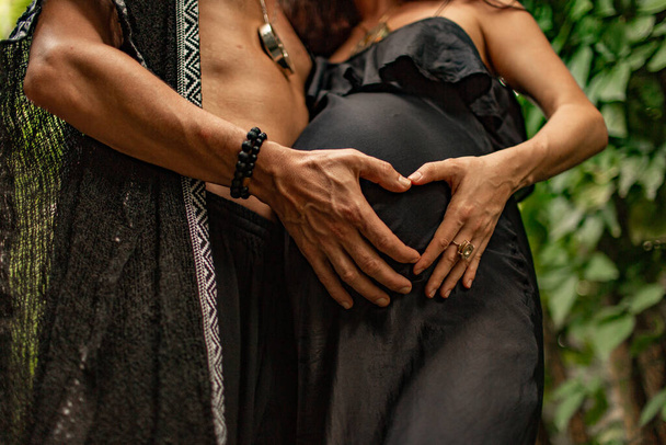 cropped shot of man and pregnant woman showing hand heart symbol on belly - Photo, image