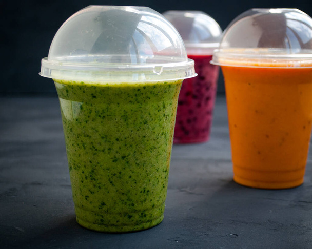 Three colorful bright smoothies - green, pink and orange - Photo, Image