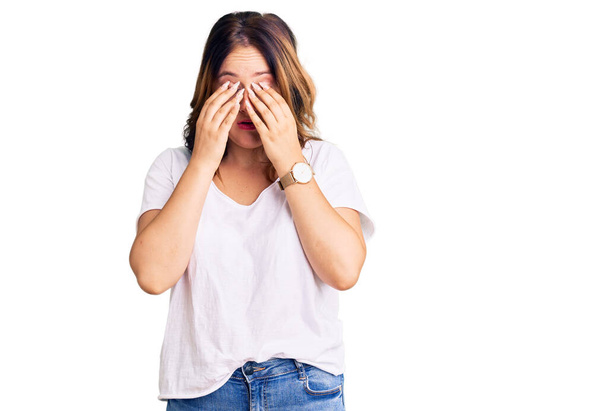 Young beautiful caucasian woman wearing casual white tshirt rubbing eyes for fatigue and headache, sleepy and tired expression. vision problem  - Photo, Image