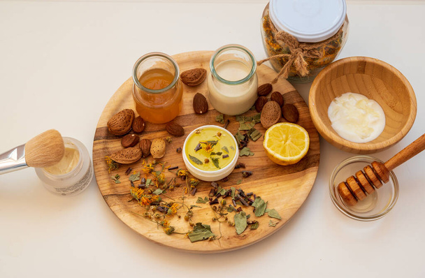 a set of natural ingredients: honey, nuts, milk, lemon on a wooden plate to prepare the cream, Chisinau, Moldova - Foto, imagen
