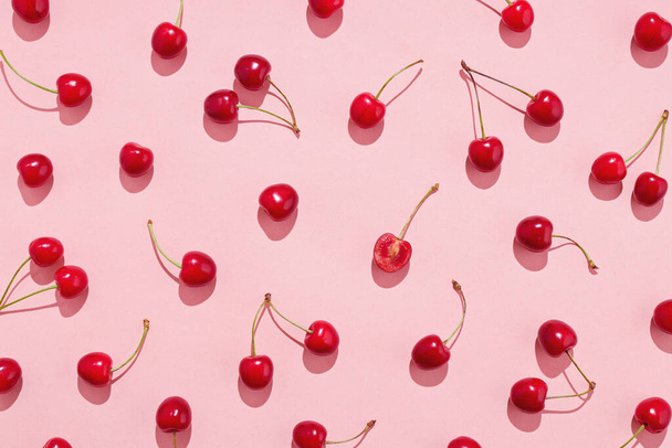 Flat lay of cherries on a pink background. Top view. - Foto, imagen