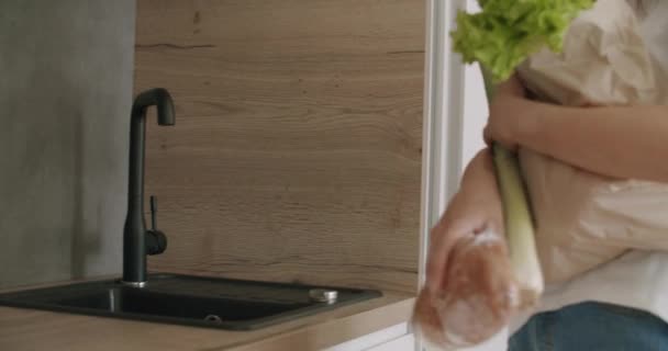 woman unpacking food bag into fridge - Video